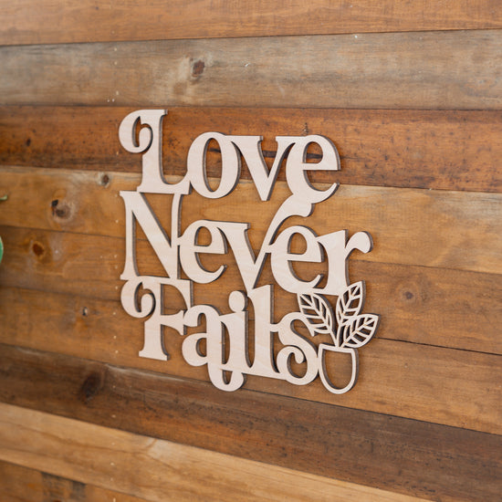 Love Never Fails Bold Wooden Plaque